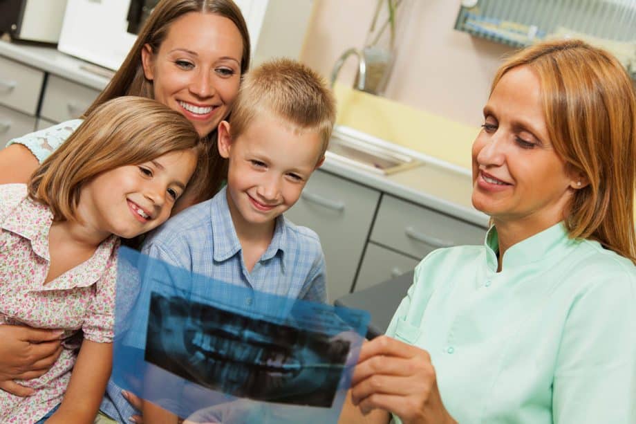 Dentist showing children xray image